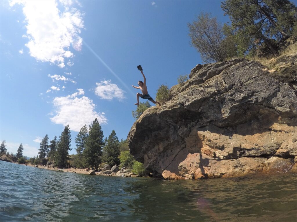 Tyler jumping from rock into lake