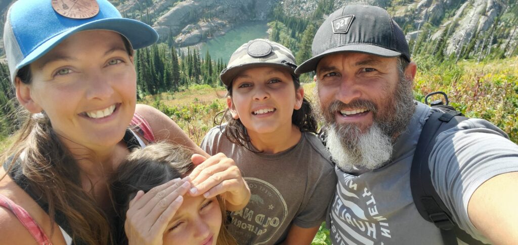 selfie of family with lake in background
